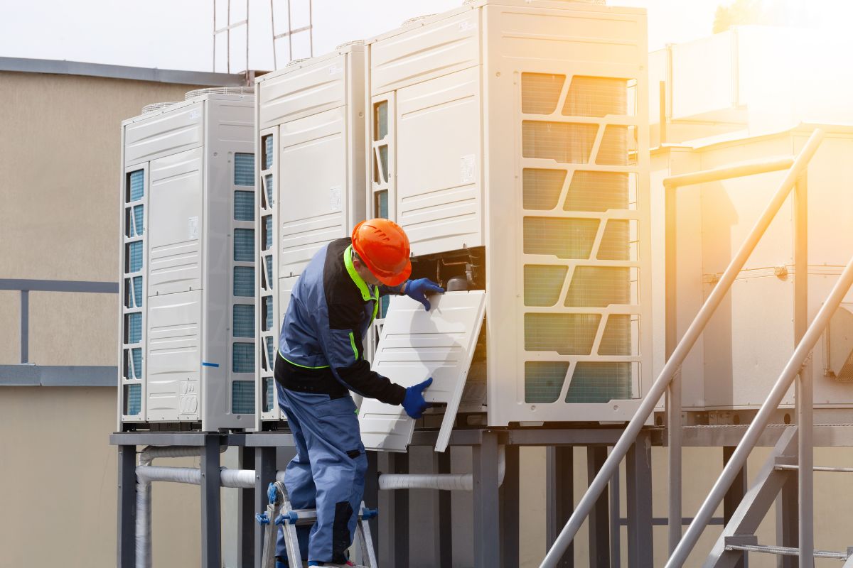 a worker conducting air compressor maintenance