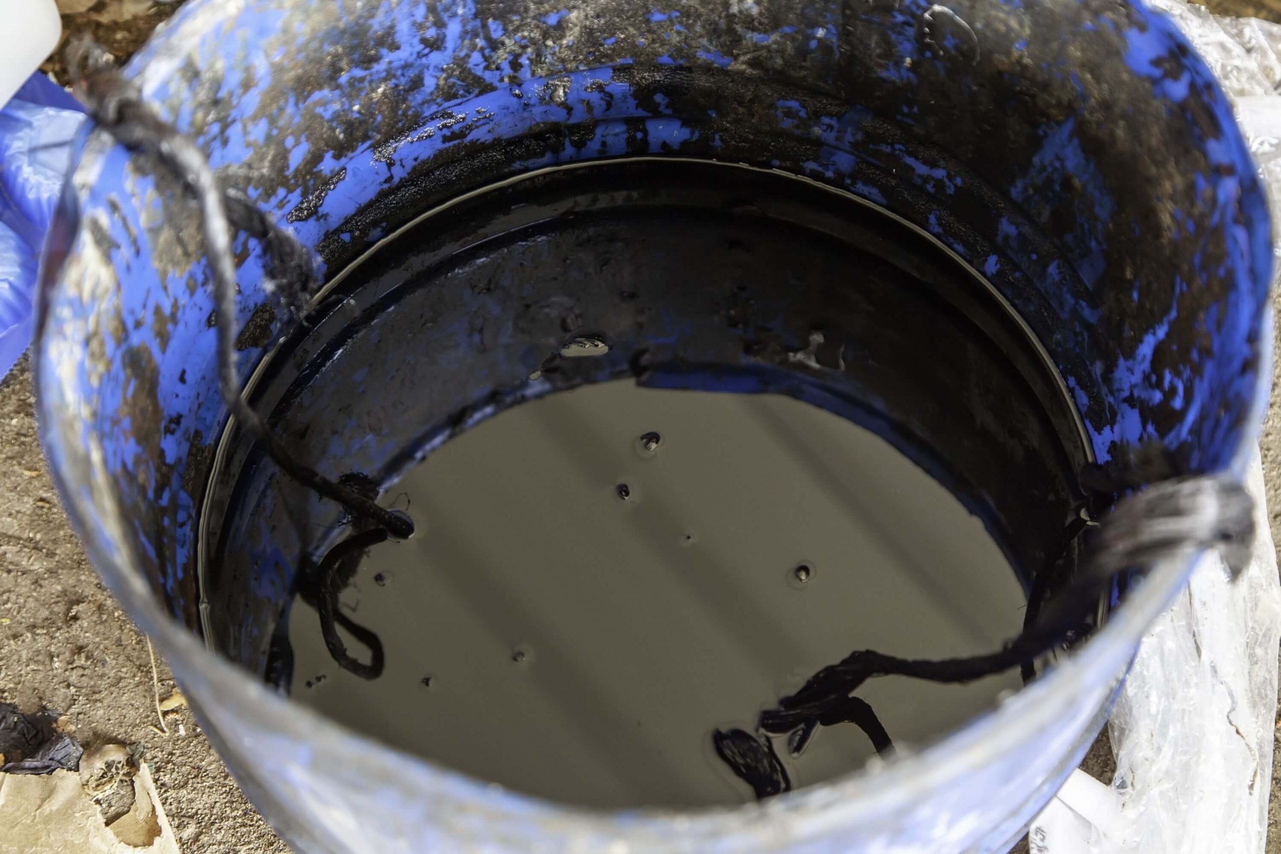dirty oil in bucket